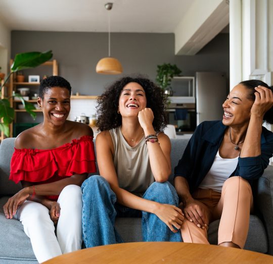 Three mixed race hispanic and black women bonding at home
